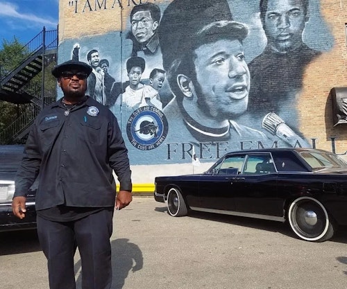 Fred Hampton Jr.  in front of his father, Fred Hampton's mural.