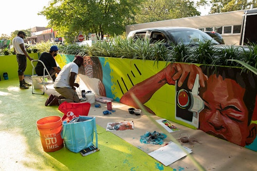 People painting a mural