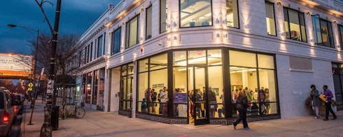 The facade of the Washington Park Arts Incubator showing guests attending an event