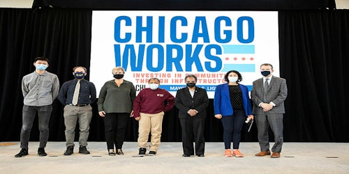 People standing on stage in front of a background that reads Chicago Works