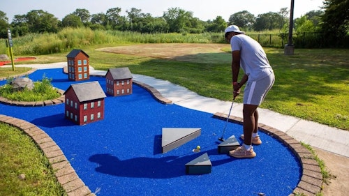 person playing mini golf