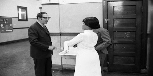 two people standing in school hallway