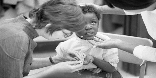 little girl being treated by nurses